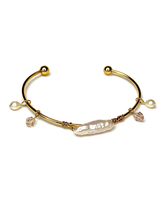 Gold bracelet with pearls and crystals on a white background