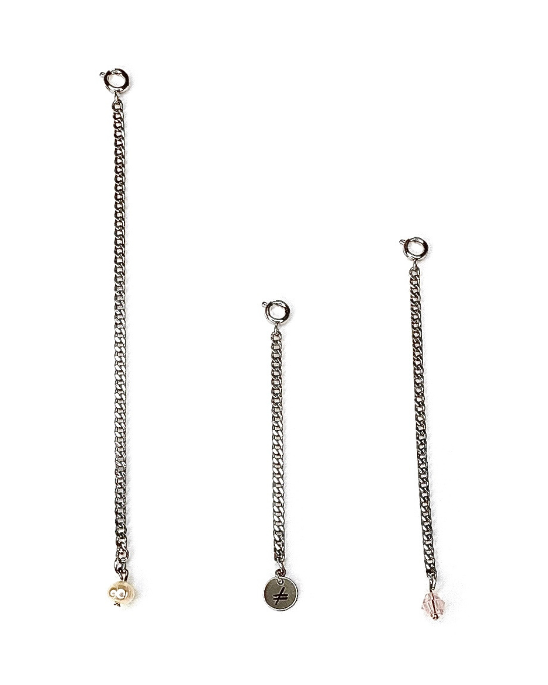 Three silver chain earrings with various pendants on a white background
