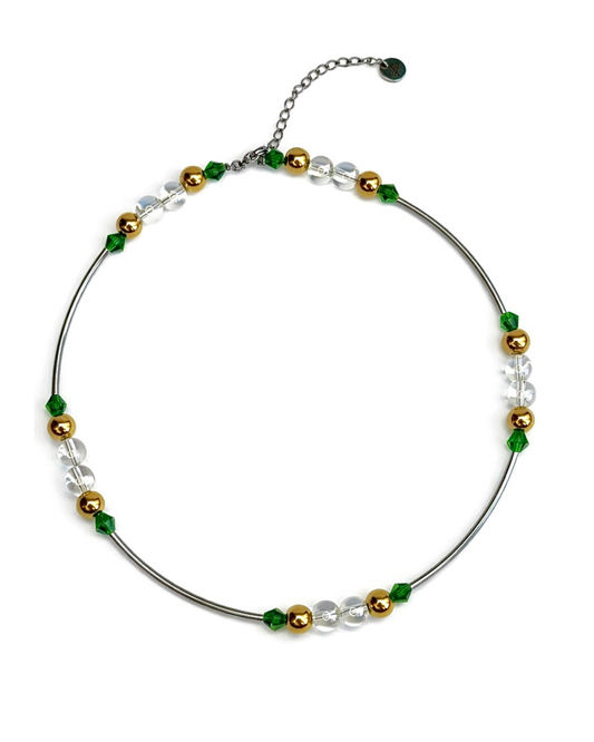 Necklace with green, gold, and clear beads on a white background
