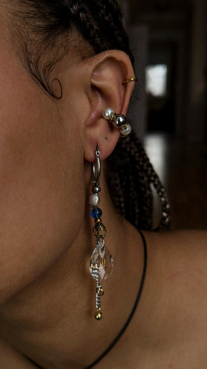 Close-up of an ear with multiple earrings and a blurred background
