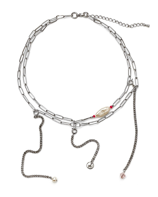 Multi-layered silver necklace with charms on a white background