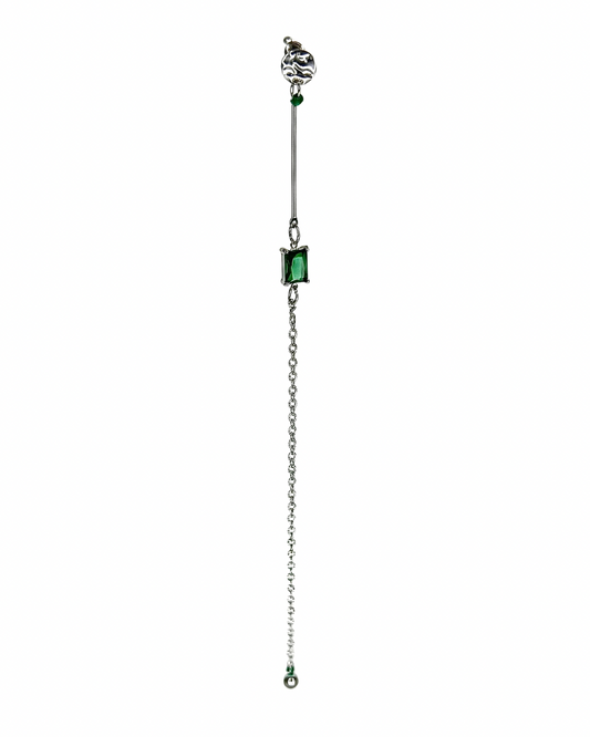 Jewelry with a chain and green gemstones on a white background